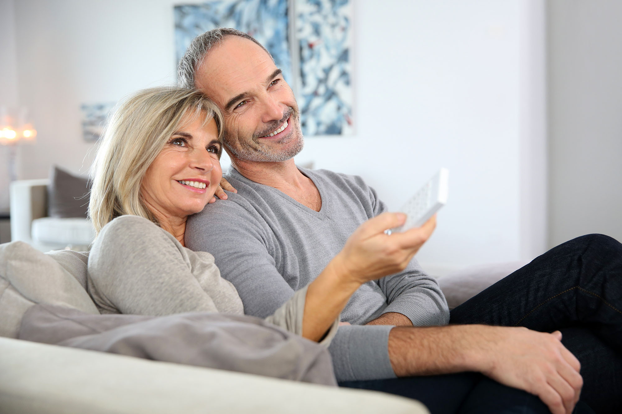 Couple watching Christian television at home